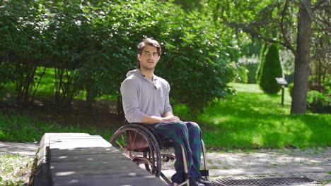 Frustrated-disabled-teenager-sitting-in-wheelchair-in-slow-motion.
